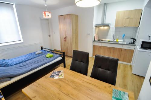 a bedroom with a bed and a table and chairs at Torus Apartments in Sarajevo
