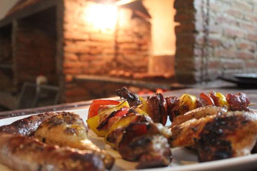 a plate of food with sausage and peppers on a table at Aparta Hotel Azzurra in Boca Chica