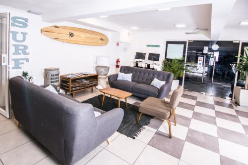 a living room with two couches and a table at Playa Hotel - Cavancha in Iquique