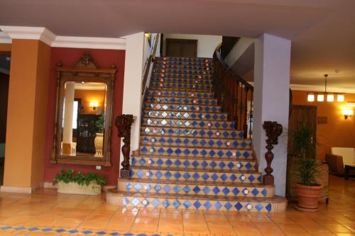 a staircase in a building with a blue runner on it at Huerta de las Palomas in Priego de Córdoba