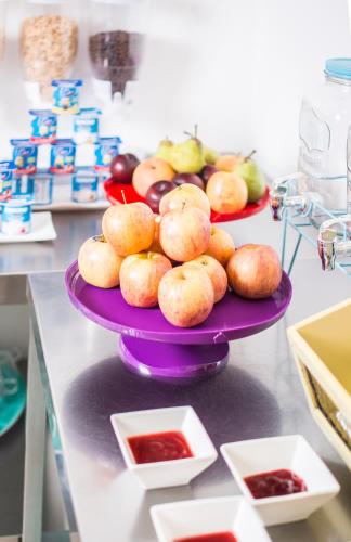 two plates of fruit on a purple plate on a counter at Playa Hotel - Cavancha in Iquique