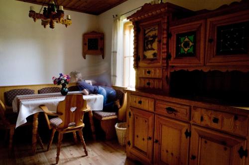 a person sitting at a table in a room at Ferienhof Rotbuchner in Vorderstoder