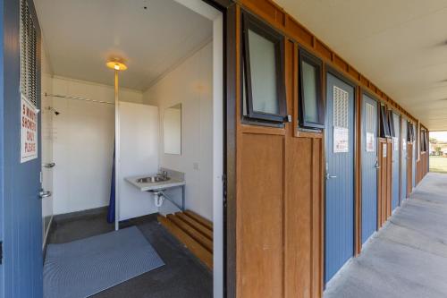 a hallway of a school building with a sink at Foxton Beach Holiday Park in Foxton Beach