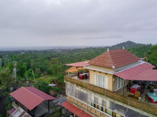 a building with red roofs with a view of a valley at Sekumpul BnB in Singaraja