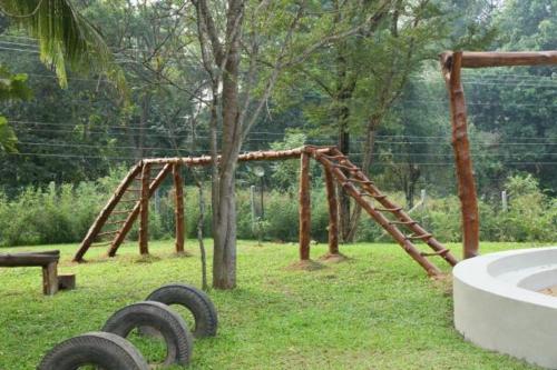 an outdoor playground with a wooden swing set at Nil Diya Mankada Safari Lodge in Udawalawe