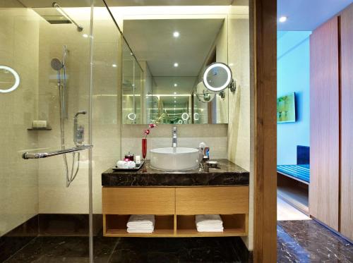 a bathroom with a sink and a shower at Vivanta Chennai IT Expressway OMR in Chennai