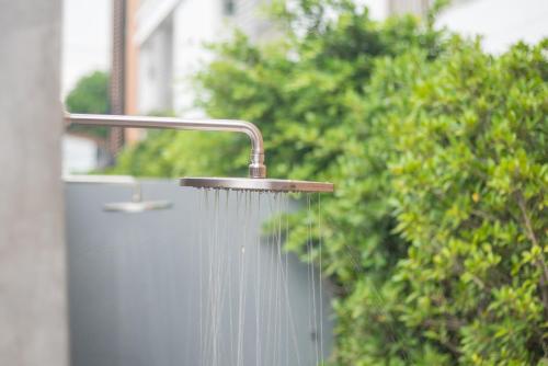 a drop of water hanging from a shower head at Koon Hotel Sukhumvit in Bangna