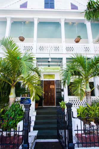 a white house with palm trees in front of it at Old Town Manor in Key West
