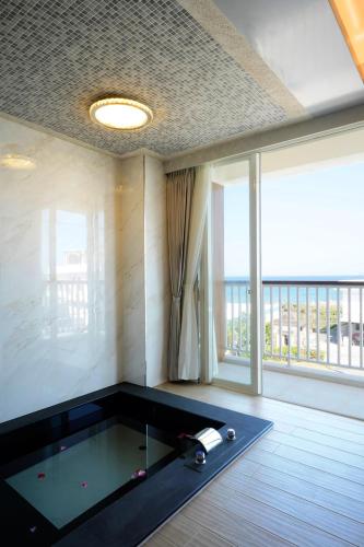 a room with a pool table and a large window at Little Piggy B&B in Manzhou