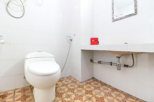 ein Badezimmer mit Toilette und Waschbecken in der Unterkunft RedDoorz Syariah at Kebun Raya Yogyakarta in Yogyakarta