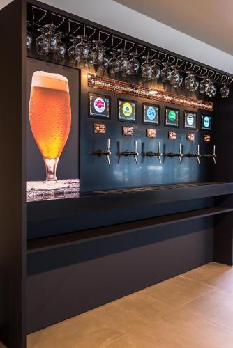 a display case with a glass of beer at Tallink Express Hotel in Tallinn