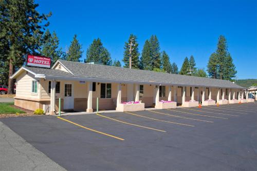 a parking lot in front of a building at Shasta Pines Motel & Suites in Burney