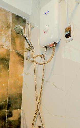 a shower in a bathroom with a hair dryer at Santa Victoria House in Chiclayo