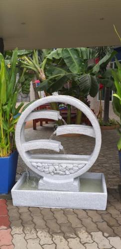 a white bench sitting next to some plants at Best Western Royal Buriram in Buriram
