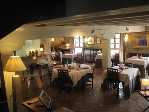 a restaurant with white tables and chairs and tablesearcher at Kuko Hotel - Adults Only in Oronoz-Mugaire