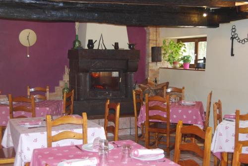 a dining room with tables and a fire place at Hostal Ezkurra in Ezkurra