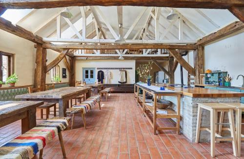 a large room with wooden beams and tables and chairs at Convivium Transilvania in Criţ