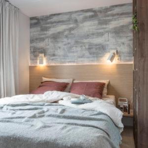 a bedroom with a large bed with red pillows at Camping Frédéric Mistral in Castellane