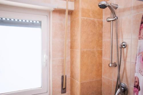 a shower with a shower head in a bathroom at Case Vacanza Torre Canne in Torre Canne