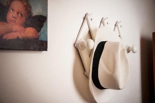 a towel hanging on a wall next to a painting at Case Vacanza Torre Canne in Torre Canne