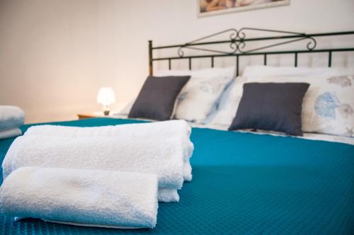 a bed with towels sitting on top of it at Case Vacanza Torre Canne in Torre Canne