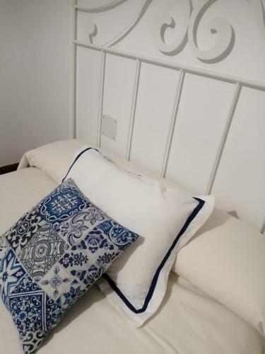 a bed with two pillows on top of it at Alcar in Bueu