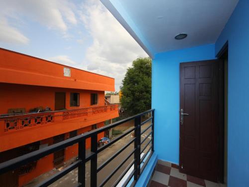 a balcony with a blue wall and a door at Max Classic Serviced Apartment in Chennai