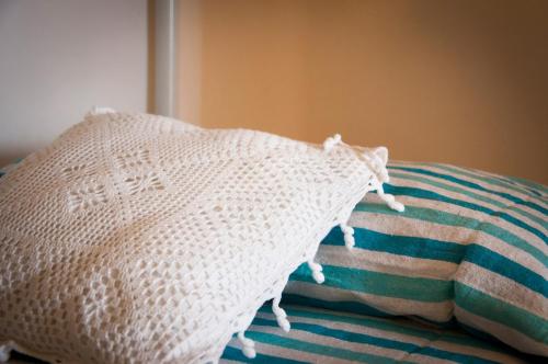 a white pillow sitting on top of a bed at Case Vacanza Torre Canne in Torre Canne