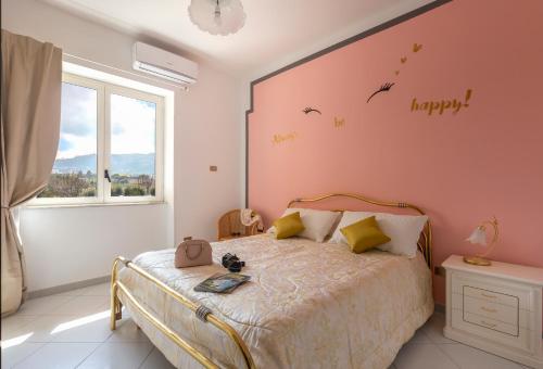 una camera da letto con un letto con parole sul muro di Seaview Cocò Home a Piano di Sorrento