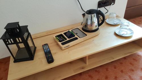 a coffee table with a tea kettle on top of it at Hotel Goldflair am Rathaus in Korbach