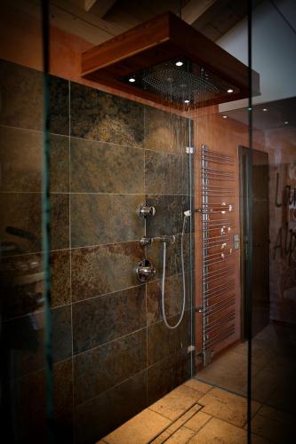 a bathroom with a shower with a glass door at Landhaus Alpengruss in Kössen