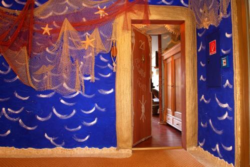 a room with a blue wall with a doorway at Hotel Goldflair am Rathaus in Korbach