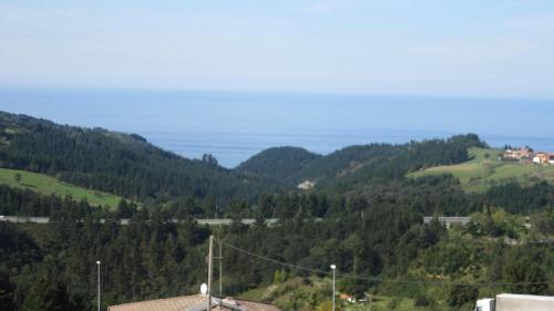 a view of a mountain with trees and houses at Hotel Kanala in Deba
