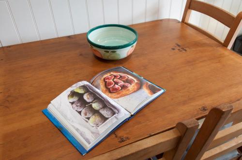 a table with a plate of sushi and a bowl of water at The Mill at Rose Villa Farm in Hereford