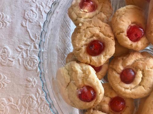 a pile of cookies with cherries on a glass plate at La Rosa dei Venti in Sennariolo