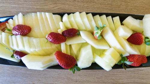 a plate of fruit with strawberries on a table at Club Maspalomas Suites & Spa - Adults Only in Maspalomas