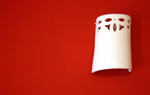 a roll of toilet paper hanging on a red wall at B&B Margherita in Ostuni