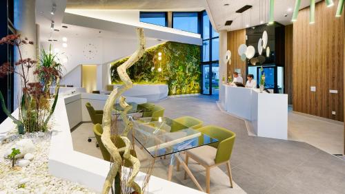 an office with a tree in the middle of a lobby at Club Maspalomas Suites & Spa - Adults Only in Maspalomas