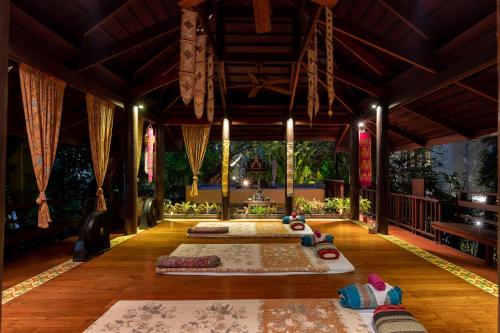 a room with three yoga mats on the floor at Ariyasom Villa in Bangkok