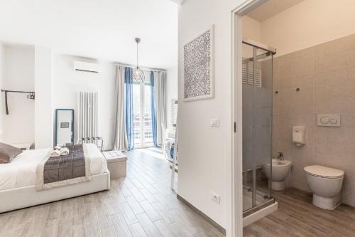 a bedroom with a bed and a shower and a toilet at Central City Rooms Executive Suite in Bologna