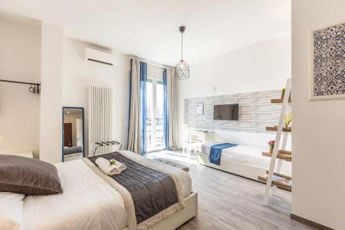 a bedroom with two beds and a ladder at Central City Rooms Executive Suite in Bologna
