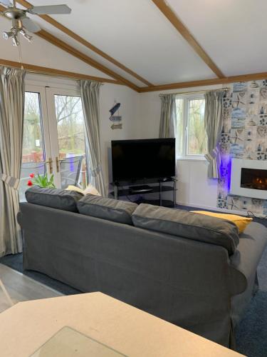 a living room with a couch and a flat screen tv at Family Holidays Blackpool in Blackpool