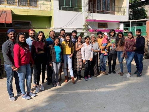 a group of people standing in front of a building at Vamoose Madhumita Homestay in Guwahati