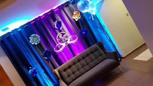 a room with blue and purple curtains and a couch at Romeo&Julia in Toruń
