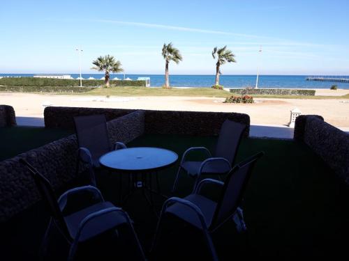 a table and chairs with a view of the beach at Seaview Chalets in Porto South Beach - Families only in Ain Sokhna