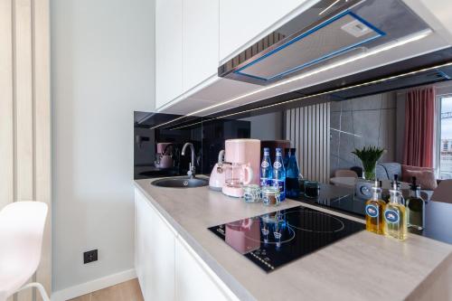 a kitchen with a counter top with a sink at Apartment Pink Flamingo by Renters in Międzyzdroje