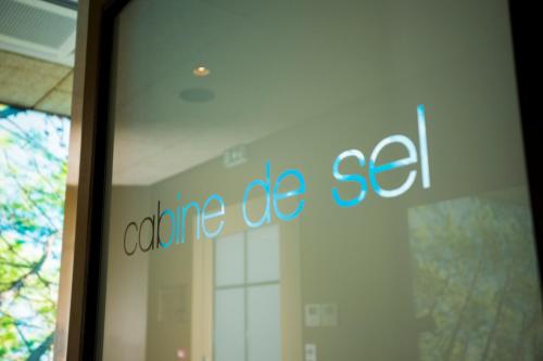 a glass door with the words captureise set on it at Hotel Clos Castel Villas Spa in Casteljaloux