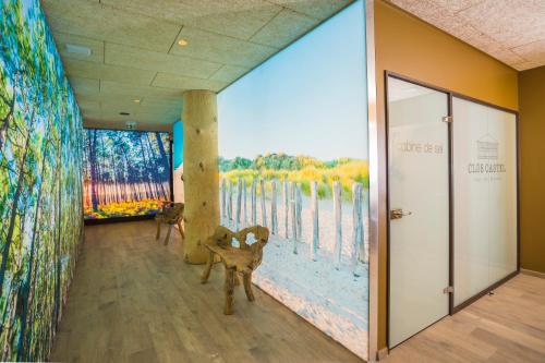 a room with a large mural on the wall at Hotel Clos Castel Villas Spa in Casteljaloux