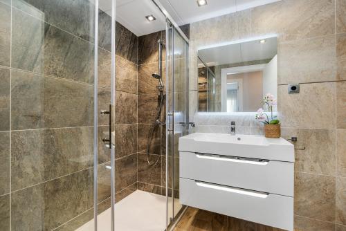 a bathroom with a shower and a sink and a mirror at PENTHOUSE CABO ROIG - ALDEAS I in Orihuela Costa