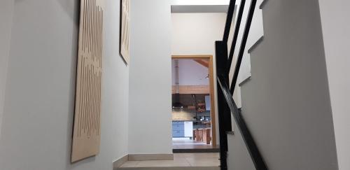 a hallway with a mirror and a stair case at Dom Goscinny Skarpa in Krynica Zdrój